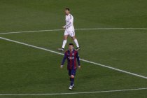 Barcelona's Argentinian forward Lionel Messi (DOWN) and genuine Madrid's Portuguese forward Cristiano Ronaldo walk on the industry during the