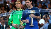 Manuel Neuer of Germany obtains the Golden Glove trophy and Lionel Messi of Argentina receives the Golden Ball